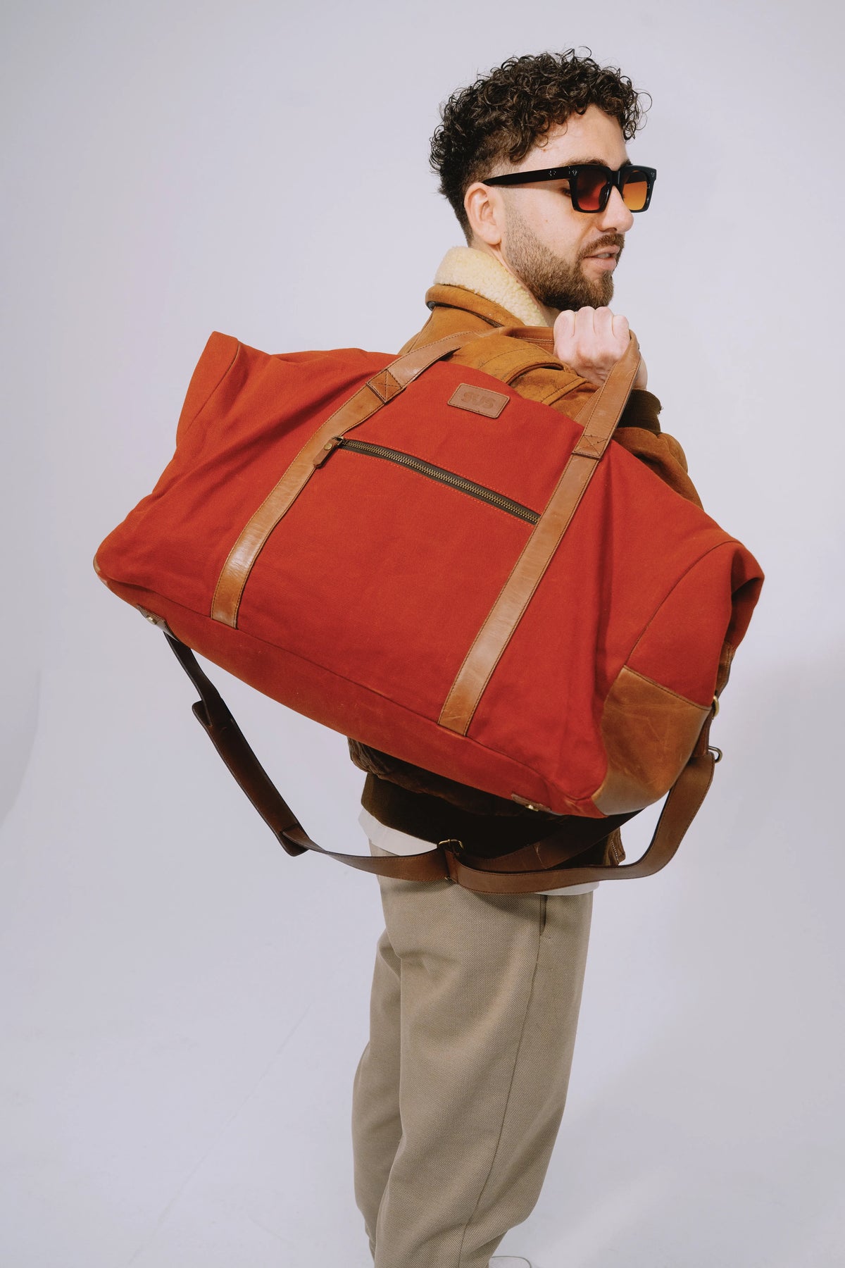Weekender burgundy bag carried comfortably with thick leather straps