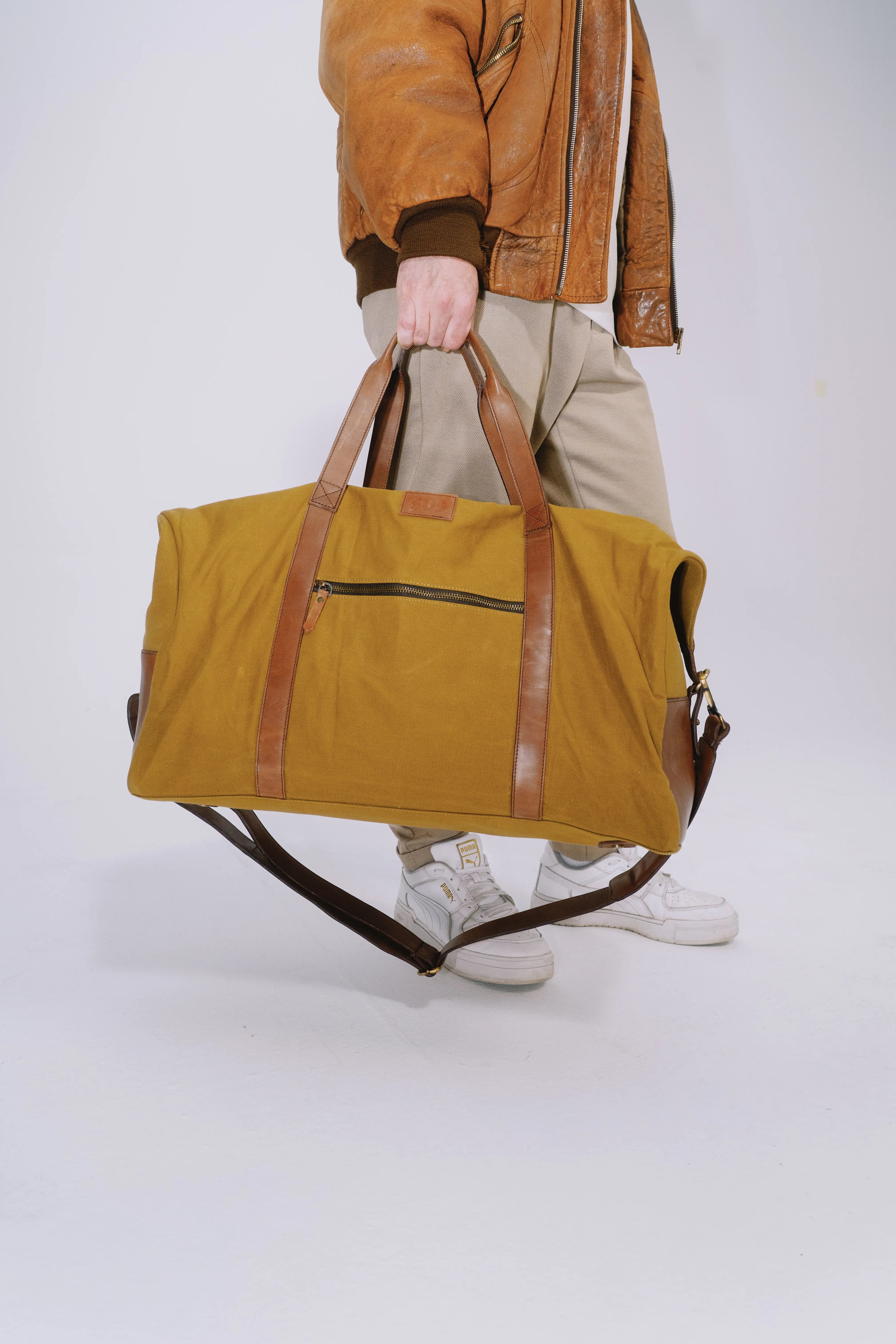 Elegant ochre duffle bag for long weekends and city travel