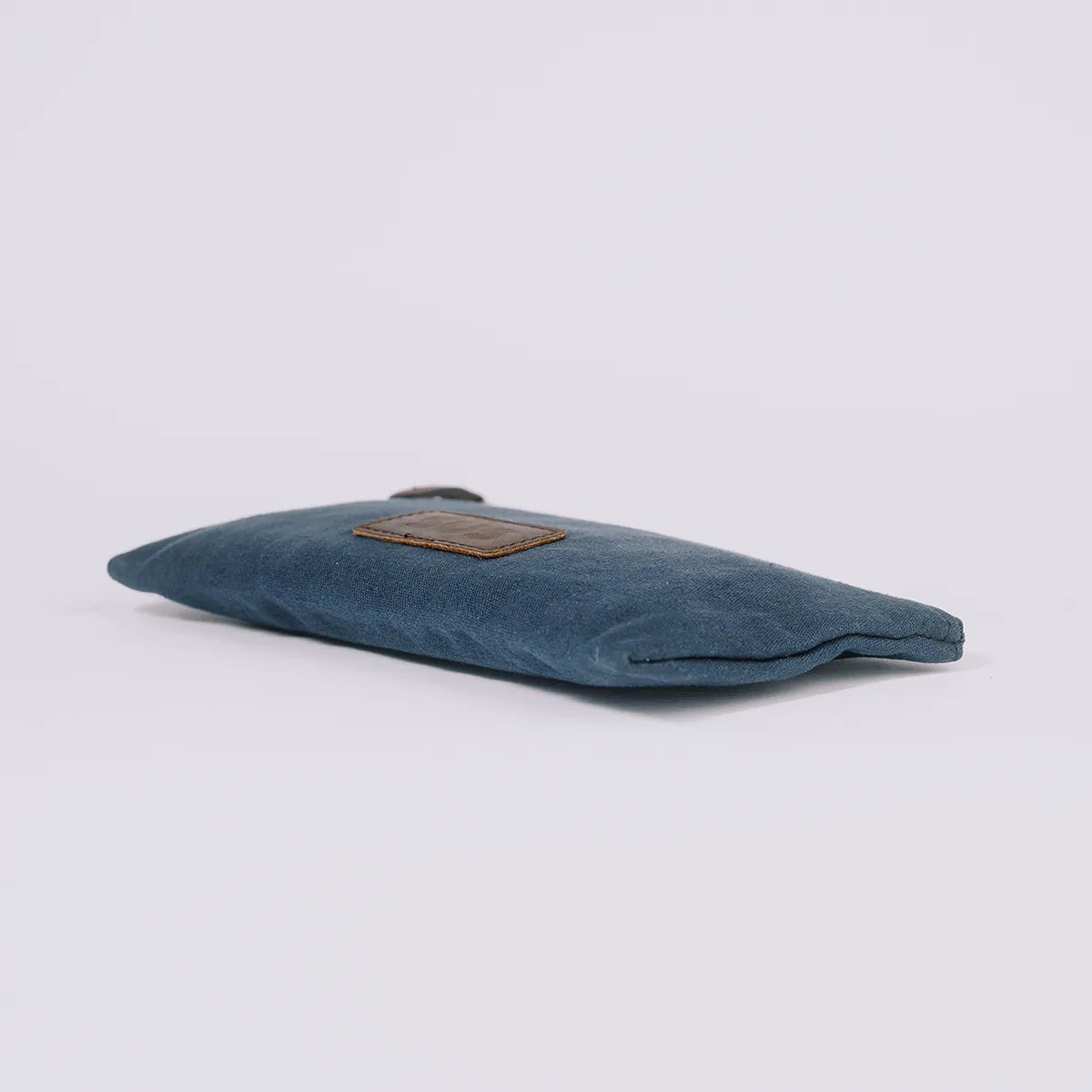 Navy blue pouch The Root Case on flat surface