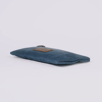 Navy blue pouch The Root Case on flat surface