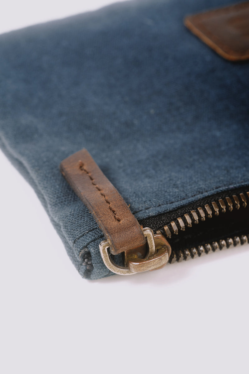 Close-up of a zipper of a navy blue pouch