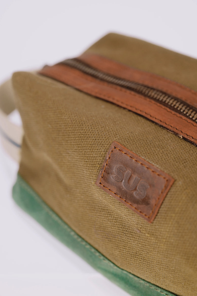 Leather SUS logo on a pale brown toiletry bag
