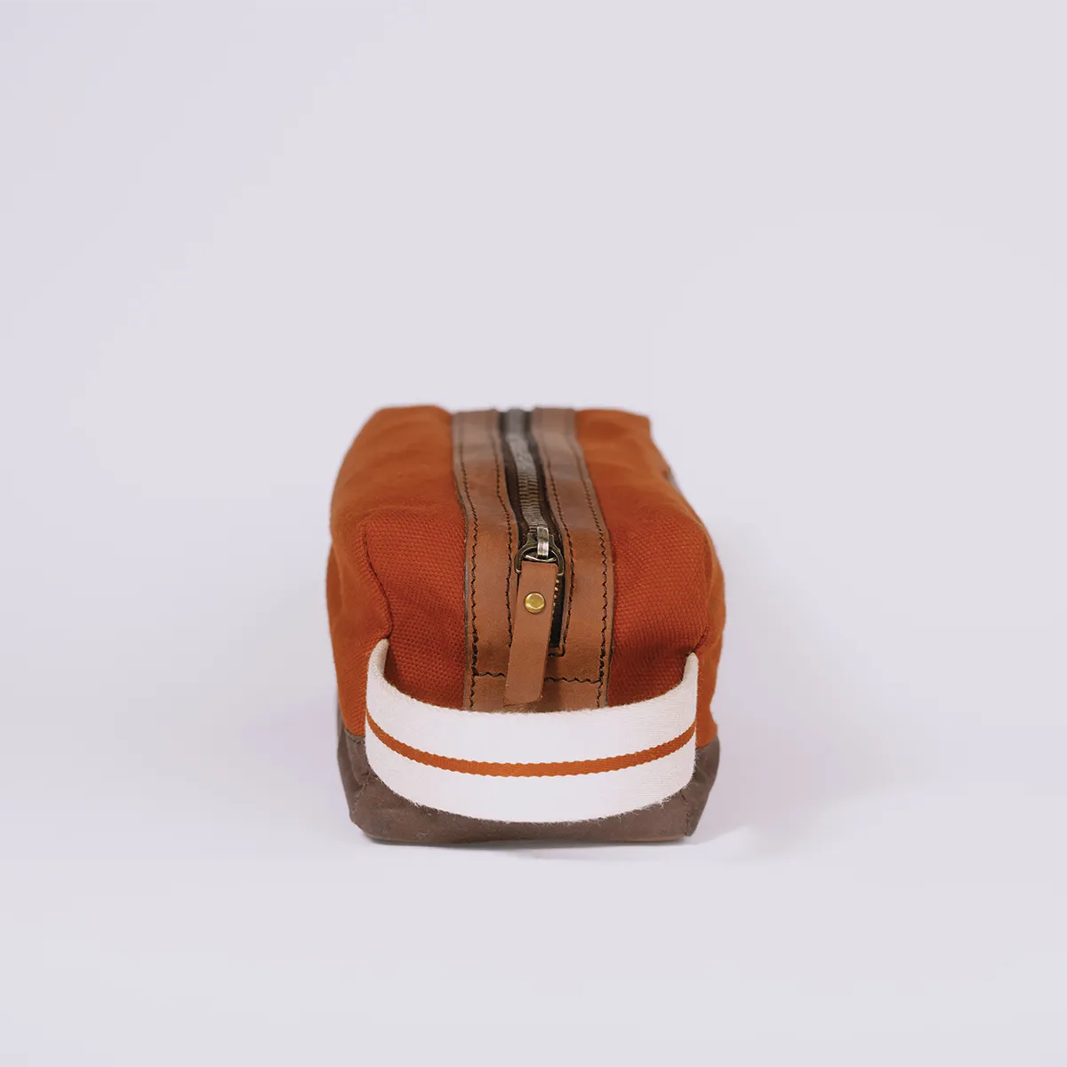 Handle of a rusty red toiletry bag