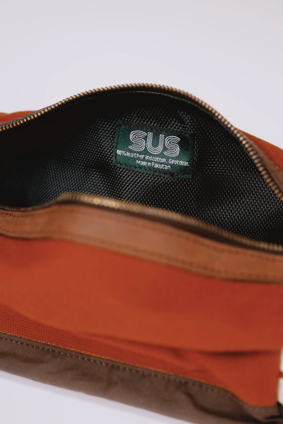 Opened SUS toiletry bag with a logo