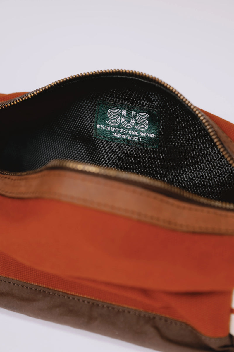 Opened SUS toiletry bag with a logo