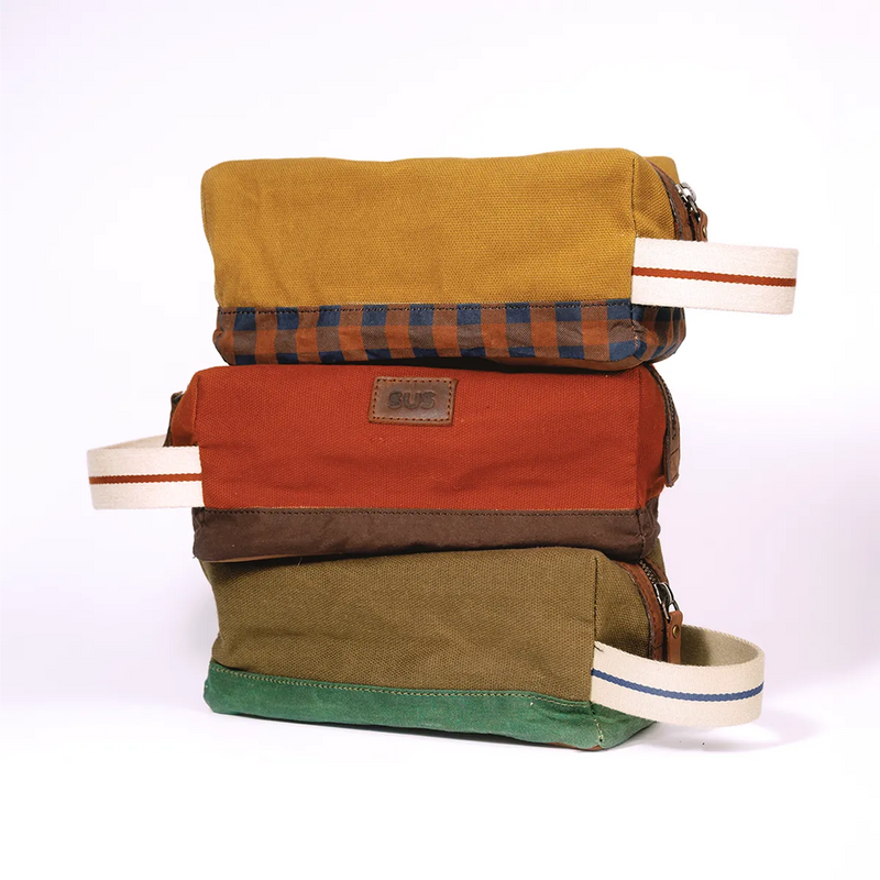 “Stacked travel toiletry bags in Golden Ochre, Pale Brown, Rusty Red
